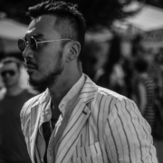 A close up of a well dressed asian man at the Pitti Uomo in Florence