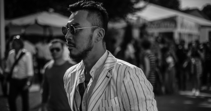A close up of a well dressed asian man at the Pitti Uomo in Florence
