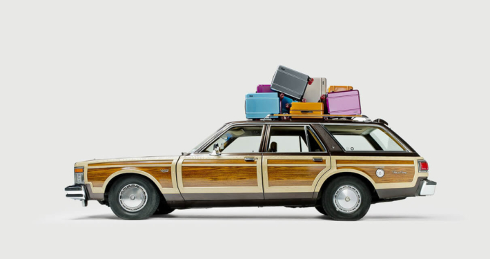 American style station wagon with a roof-rack full of Floyd Suitcases