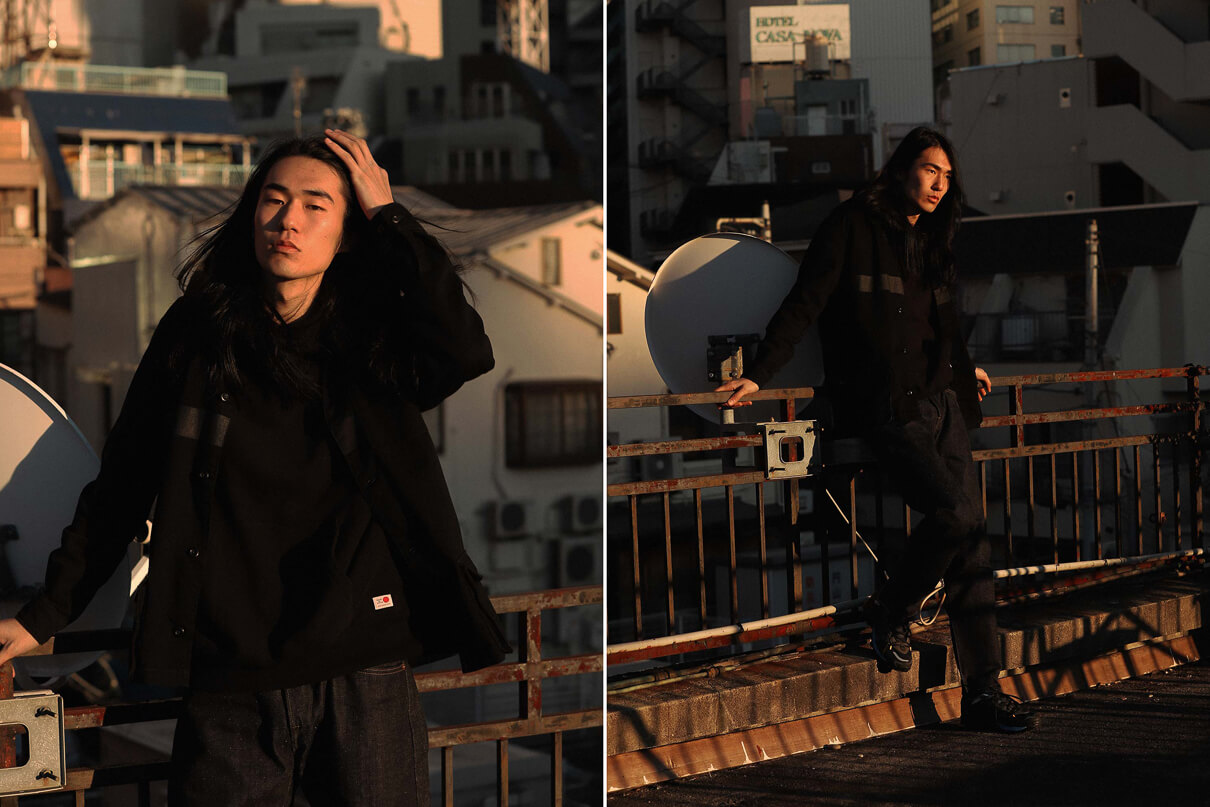 A Japanese man on a rooftop in Tokyo wearing raw denim jeans from Edwin, taken from the Edwin made in Japan lookbook for Spring Summer 2020