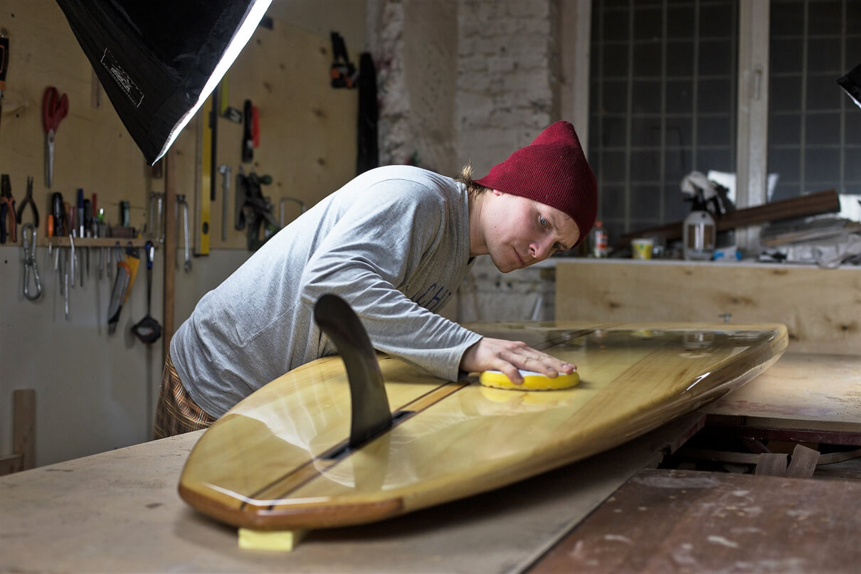 A Mitrich paddleboard being polished by founder Nick.